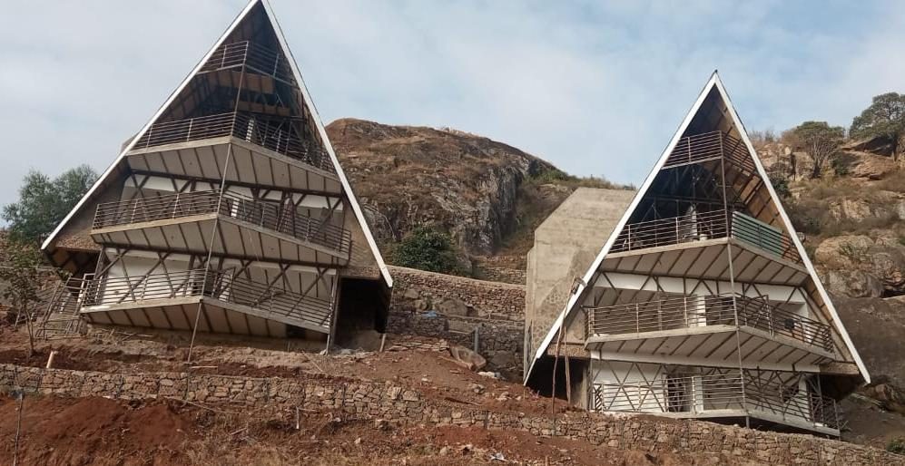 Twin A-frame resort cabins under construction, Machakos